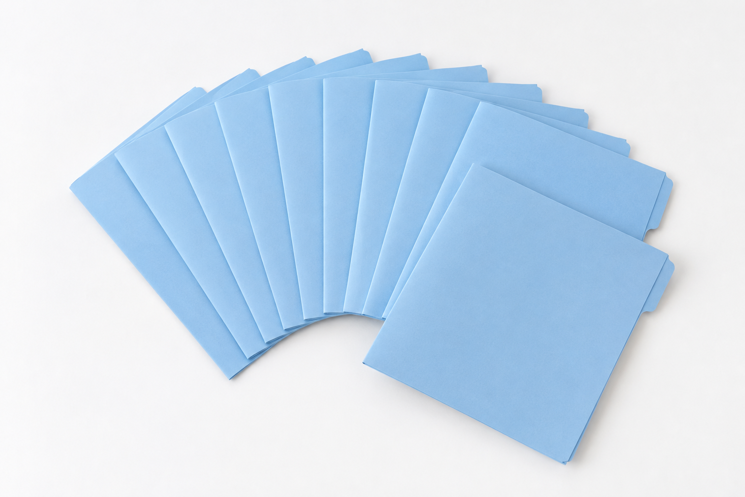 Eleven identical folders fanned out on a white table